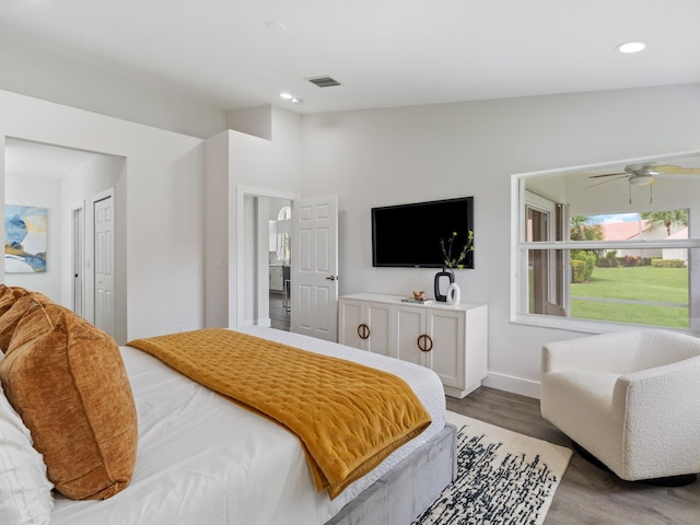 bedroom with vaulted ceiling, a closet, and light wood-type flooring