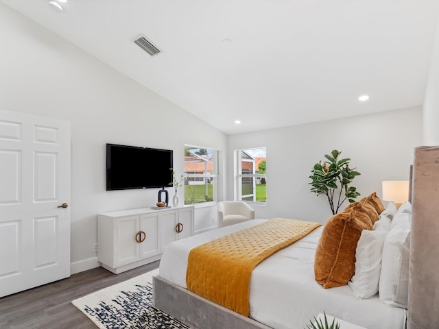 bedroom featuring hardwood / wood-style floors and vaulted ceiling