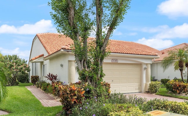 view of home's exterior with a garage and a lawn