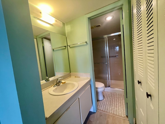 bathroom with walk in shower, toilet, hardwood / wood-style floors, and vanity