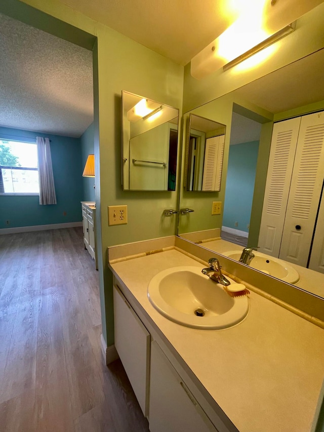 bathroom featuring vanity, a textured ceiling, and hardwood / wood-style flooring