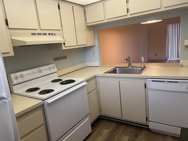 kitchen featuring white appliances, white cabinets, dark wood-type flooring, custom exhaust hood, and sink