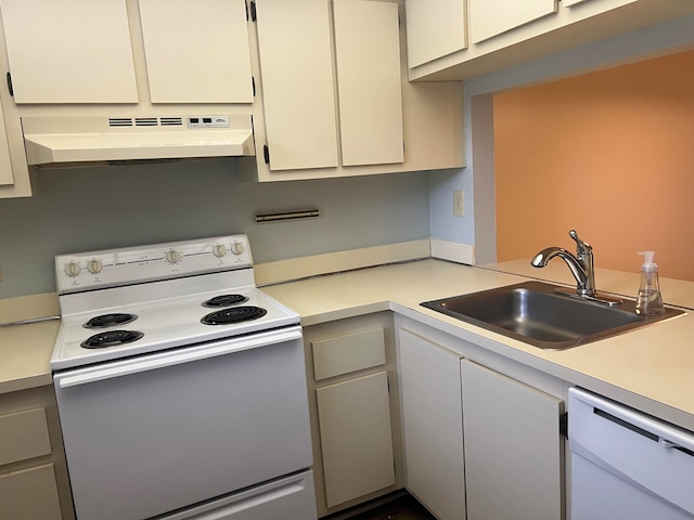 kitchen featuring sink, white appliances, wall chimney exhaust hood, and white cabinetry