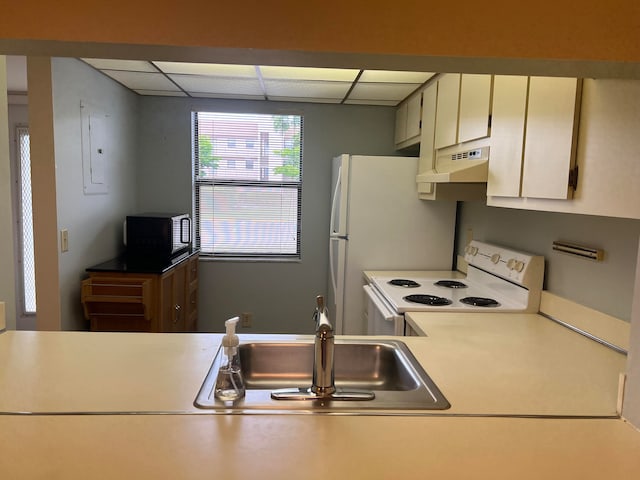 kitchen featuring built in microwave, white cabinets, sink, a paneled ceiling, and white electric stove