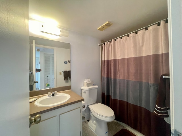 bathroom featuring vanity, toilet, and tile patterned floors