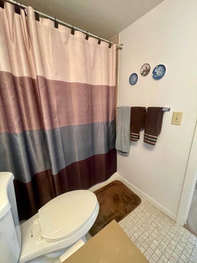 bathroom with toilet and tile patterned floors