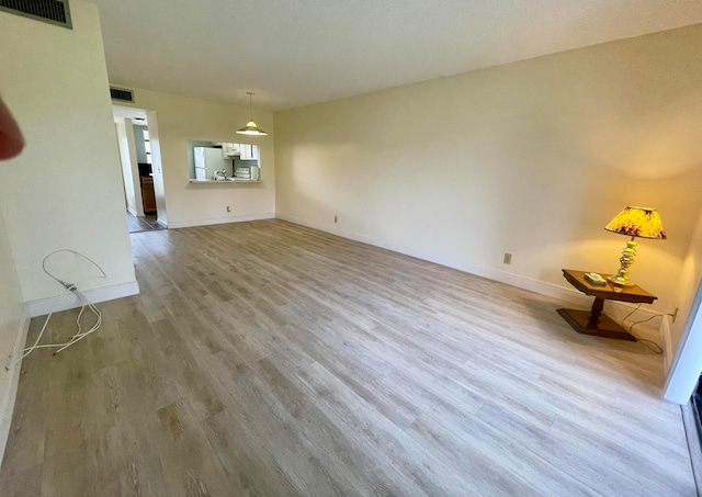 unfurnished living room featuring hardwood / wood-style floors