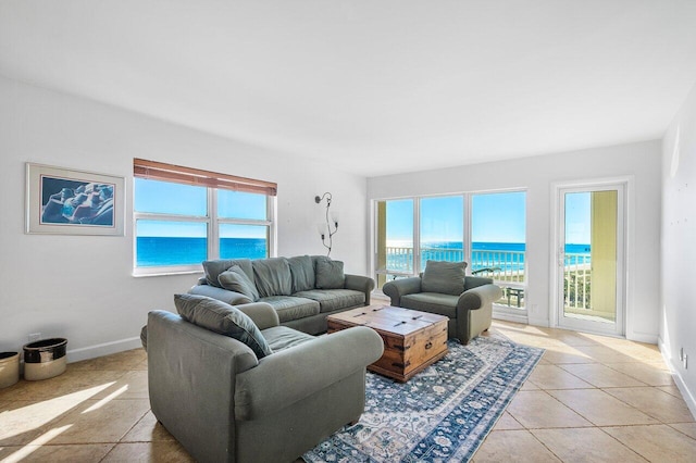 living room with a water view and light tile patterned flooring