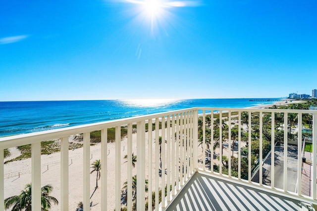 balcony with a beach view and a water view