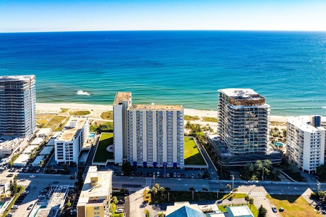 bird's eye view with a water view and a beach view