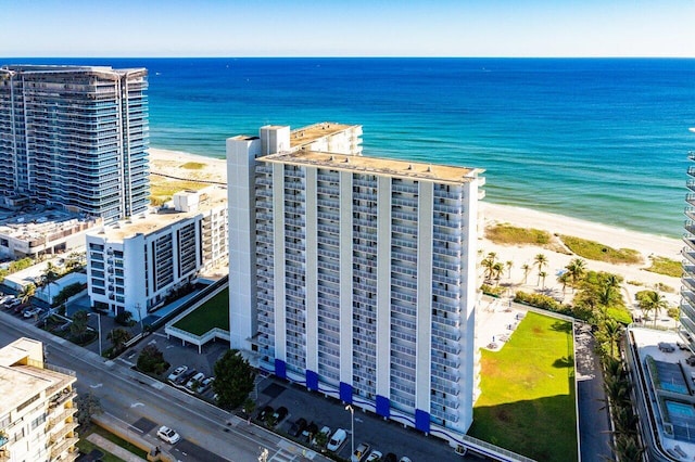 drone / aerial view with a water view and a beach view