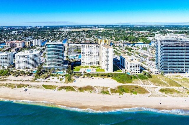 birds eye view of property with a view of the beach and a water view