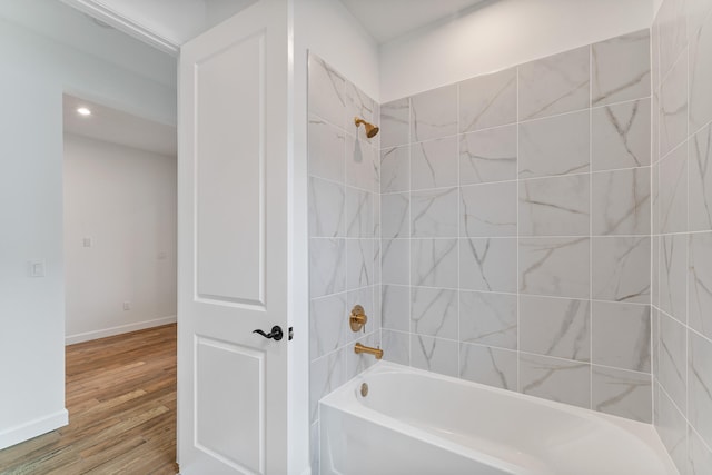 bathroom featuring hardwood / wood-style flooring and tiled shower / bath combo