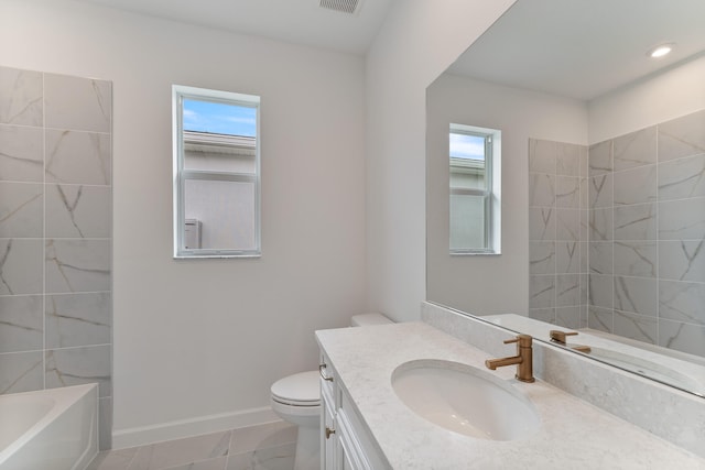 bathroom with vanity, toilet, and tile patterned floors