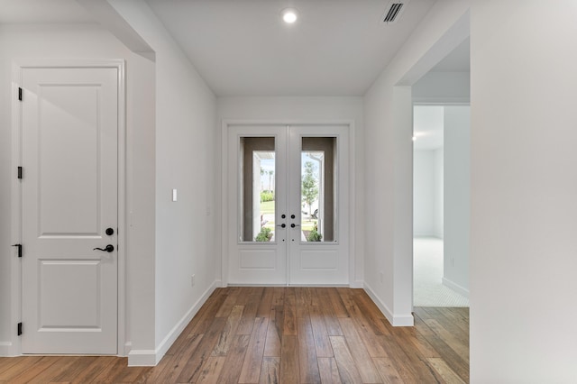 foyer entrance featuring hardwood / wood-style flooring and french doors