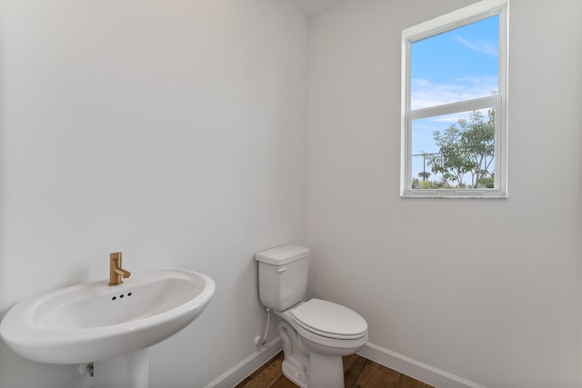 bathroom with sink, toilet, and hardwood / wood-style flooring