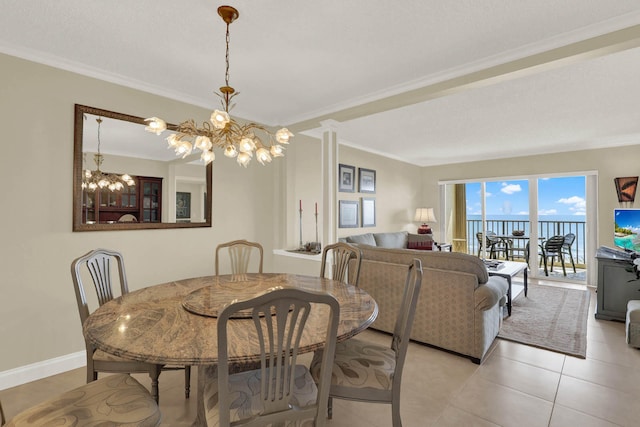 dining space with light tile patterned floors, a chandelier, and ornamental molding