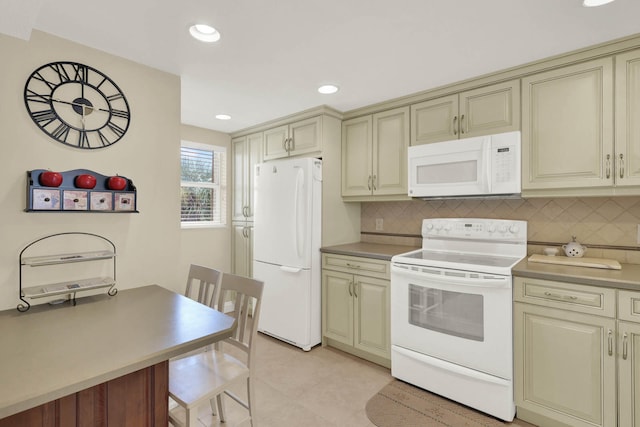 kitchen featuring light tile patterned floors, cream cabinetry, decorative backsplash, and white appliances