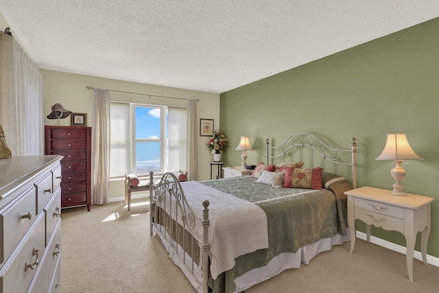 carpeted bedroom featuring a textured ceiling