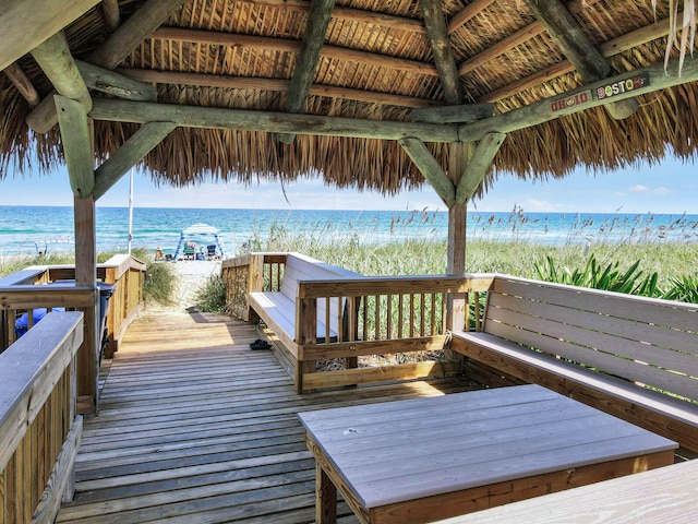 wooden terrace featuring a gazebo and a water view