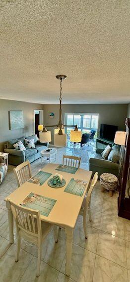 dining room with a textured ceiling and light tile patterned floors