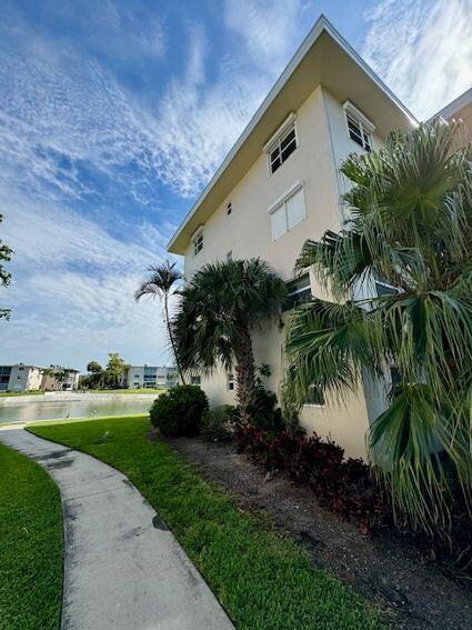 view of side of home with a lawn