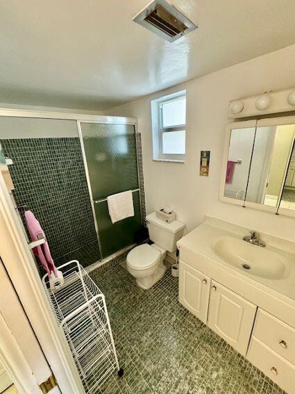 bathroom featuring toilet, vanity, and tile patterned floors