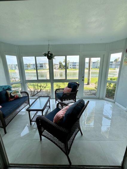 sunroom featuring a notable chandelier