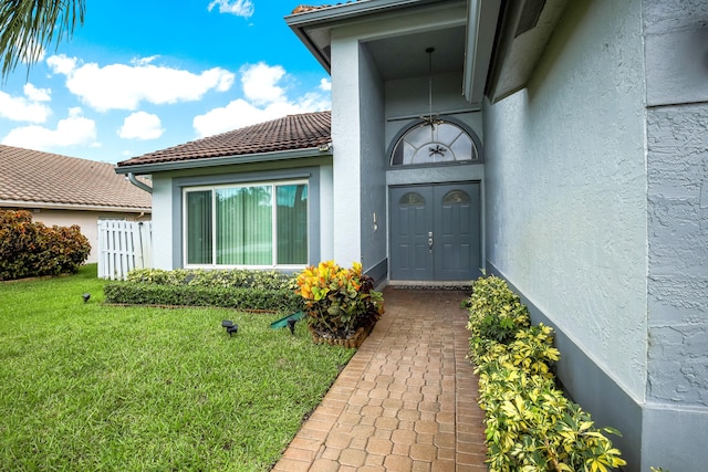 doorway to property with a yard