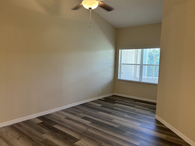 spare room featuring dark hardwood / wood-style floors, ceiling fan, and a textured ceiling