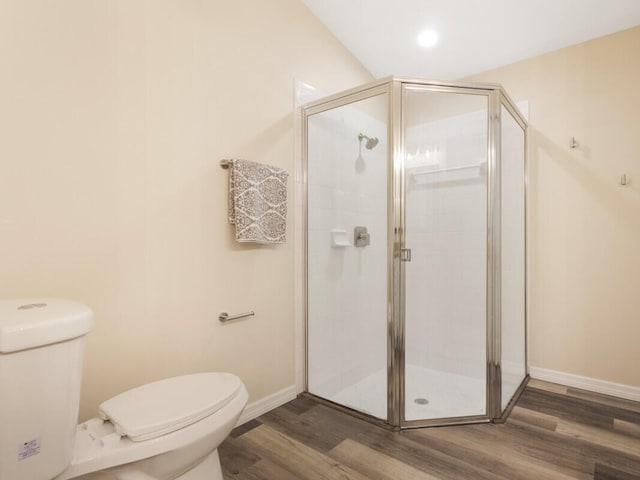 6166 Lake Hibiscus Dr, Delray Beach, FL 33484 - bathroom with toilet, wood finished floors, a stall shower, and baseboards