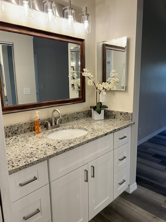 bathroom with vanity and wood-type flooring