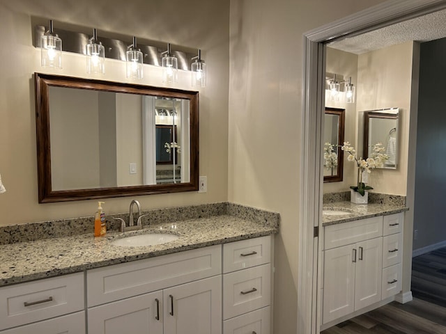 bathroom with double sink vanity and hardwood / wood-style floors