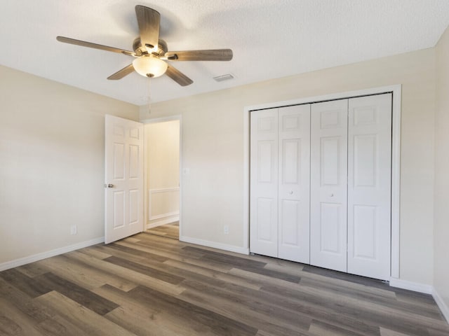 6166 Lake Hibiscus Dr, Delray Beach, FL 33484 - unfurnished bedroom with wood finished floors, baseboards, and a closet