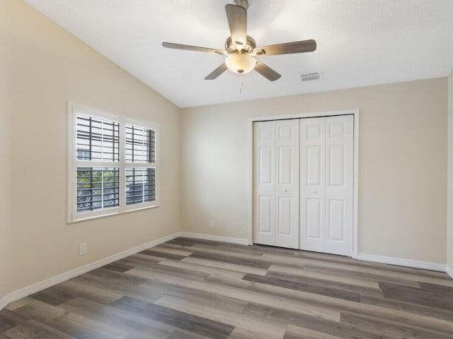 6166 Lake Hibiscus Dr, Delray Beach, FL 33484 - unfurnished bedroom with wood finished floors, a closet, baseboards, vaulted ceiling, and a ceiling fan
