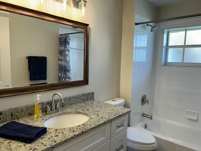 full bathroom featuring vanity, shower / bath combo, and toilet