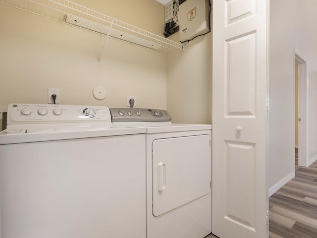 6166 Lake Hibiscus Dr, Delray Beach, FL 33484 - laundry room with washing machine and dryer, light wood-style floors, and baseboards