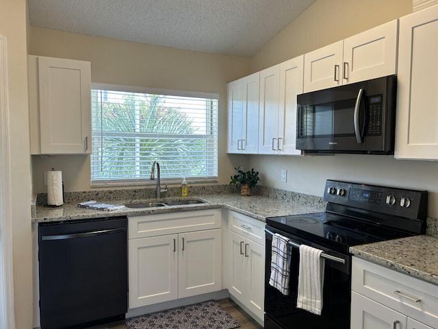 kitchen with sink, white cabinetry, and black appliances