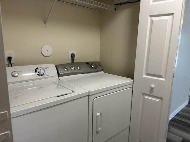 washroom with dark wood-type flooring and washing machine and clothes dryer