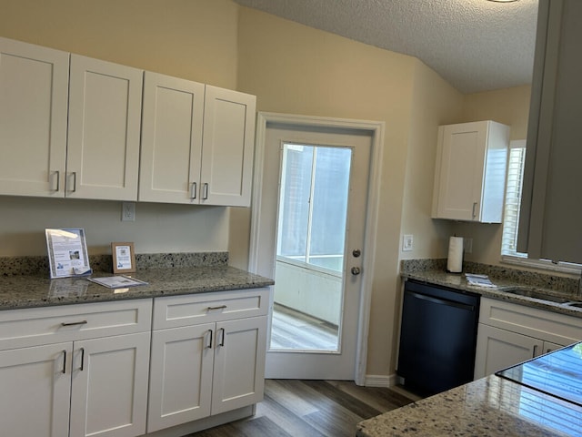 kitchen featuring hardwood / wood-style flooring, black appliances, light stone counters, and sink