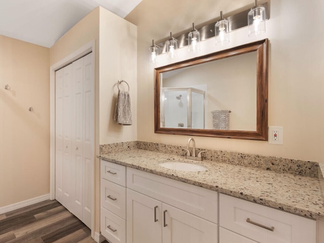 6166 Lake Hibiscus Dr, Delray Beach, FL 33484 - full bathroom with vanity, wood finished floors, a stall shower, and baseboards