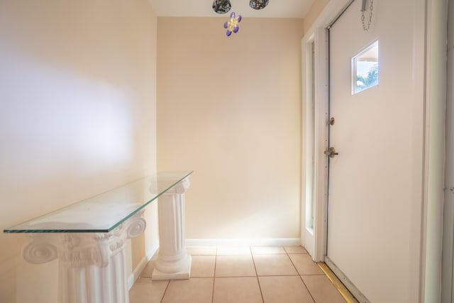 doorway to outside with light tile patterned flooring