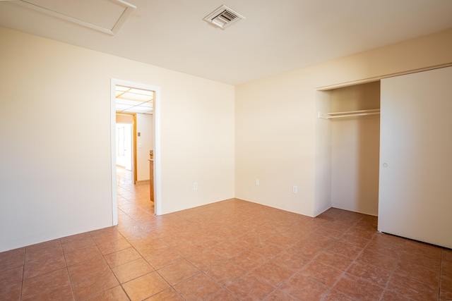 unfurnished bedroom featuring a closet and tile patterned floors