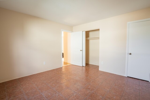 unfurnished bedroom with a closet