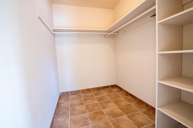 spacious closet with tile patterned floors