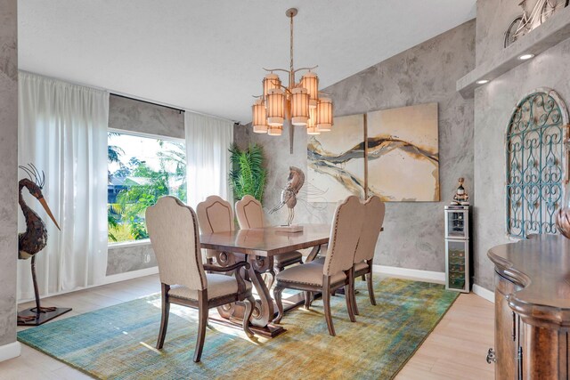 dining space featuring wood-type flooring and a chandelier