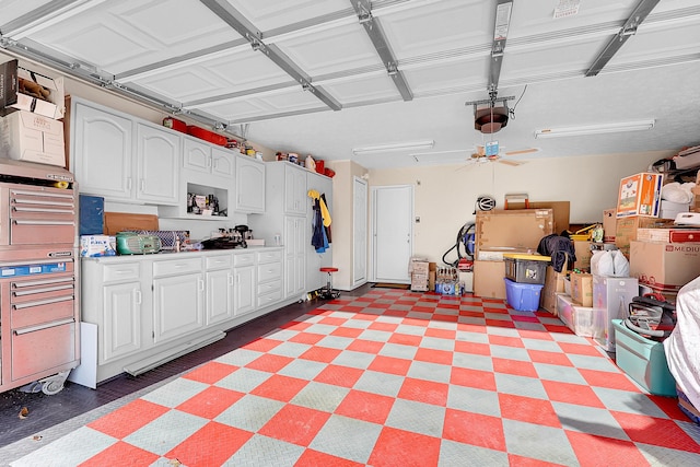 garage with ceiling fan and a garage door opener