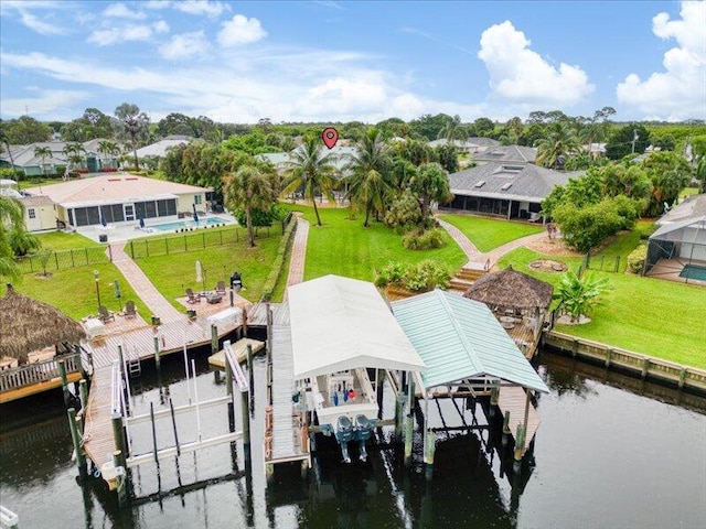 view of dock with a water view and a yard