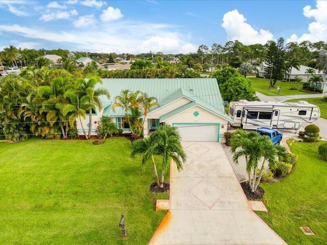 view of front of property featuring a garage and a front yard