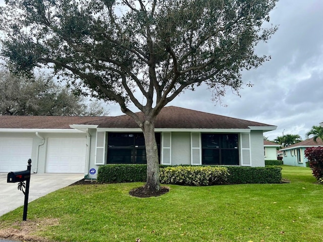 ranch-style home featuring a garage and a front yard